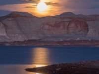 Beautiful night image of a moon cresting over the cliffs of Lake Powell. - photo by Gary Ladd