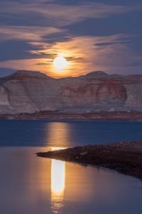 Beautiful night image of a moon cresting over the cliffs of Lake Powell. - photo by Gary Ladd
